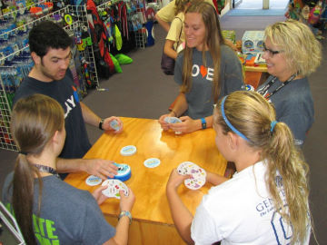The staff takes time to learn a new game with our Blue Orange rep
