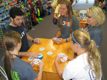 The staff takes time to learn a new game with our Blue Orange rep The staff takes time to learn a new game with our Blue Orange rep
