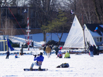 An ice boat and a snowkiter share the field at teh Reeds Lake Ice Fly An ice boat and a snowkiter share the field at teh Reeds Lake Ice Fly